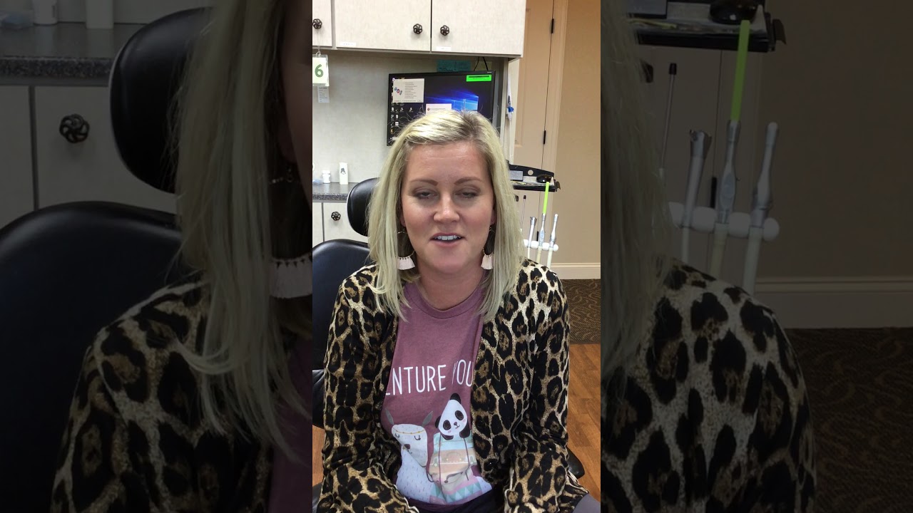 Woman wearing leopard print jacket in dental office