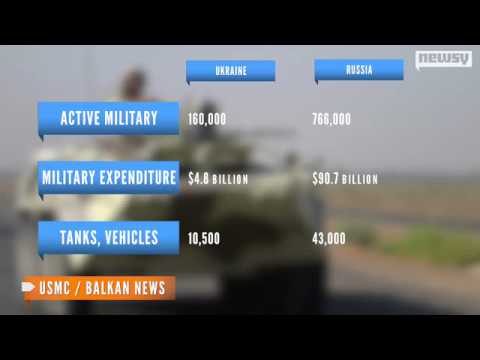 Hundreds of armed men in trucks and armored vehicles surrounded a Ukrainian military