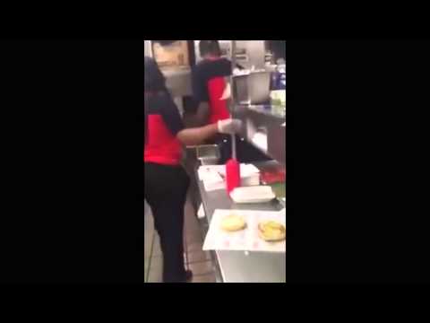 Vuz.fr Checkers fast food worker wiping burger bun on floor