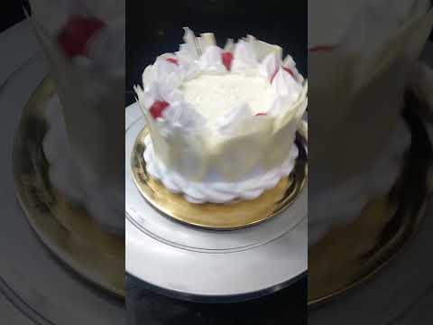 white forest cake garnish with white chocolate and cherry