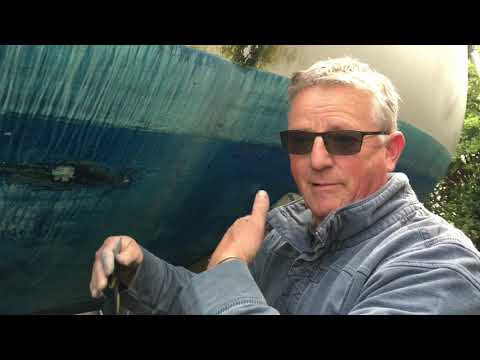 Boat surveyor inspects the hull, antifouling and keel of a Maxi 84