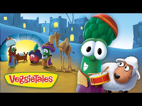 Animated VeggieTales scene with a green broccoli drummer and a sheep on a sandy town square, bright colors in the background.