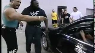 Mark Henry trys to hold back a limo with his legs for 30 seconds