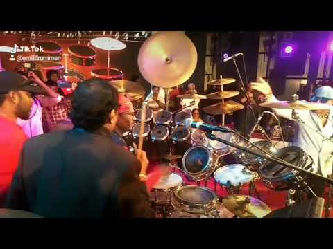 Emildrummer playing drums in front of Drums Sivamani