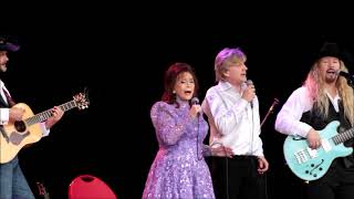 Loretta singing Where no one stands alone