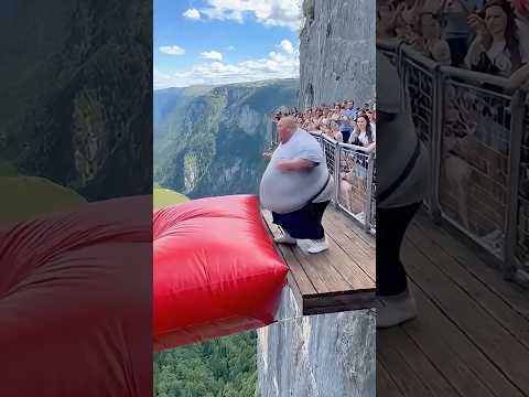 Cliff airbag is wild! 🔥💥 Guy jumps, girl flies! #ScaryRide #TravelWonder