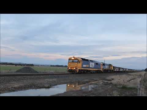 8129+X50 bring #7727 Geelong to Murtoa empty grain train through Langi Logan, Victoria at dusk.