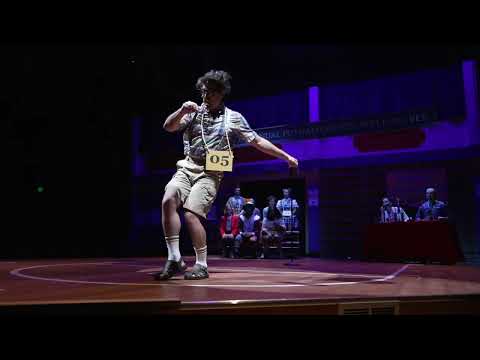 Trailer still of a soloist at the microphone during a heartfelt Spelling Bee ballad