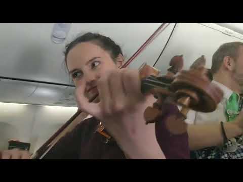 Irish Woman Celebrates St. Patrick's Day With Fiddle Session on Flight to Dublin
