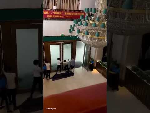 Staff cling onto doors as super Typhoon hits hotel