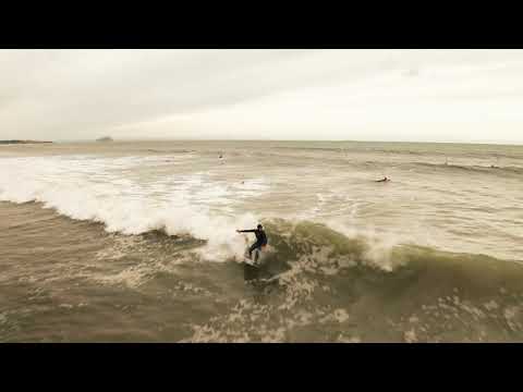 Drone shots of surfers on fun waves at Belhaven Bay