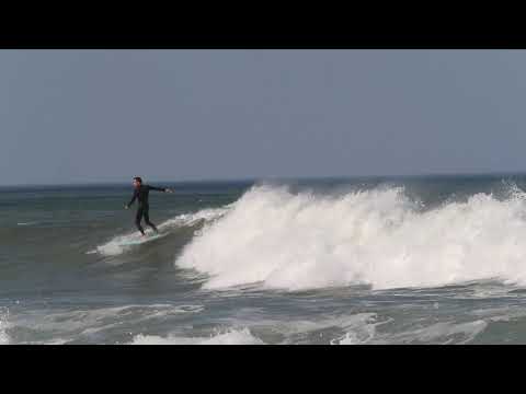Surfers hit the waves off of Brant Rock