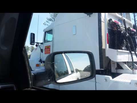 Kenworth T600 hauling John Deere tractors
