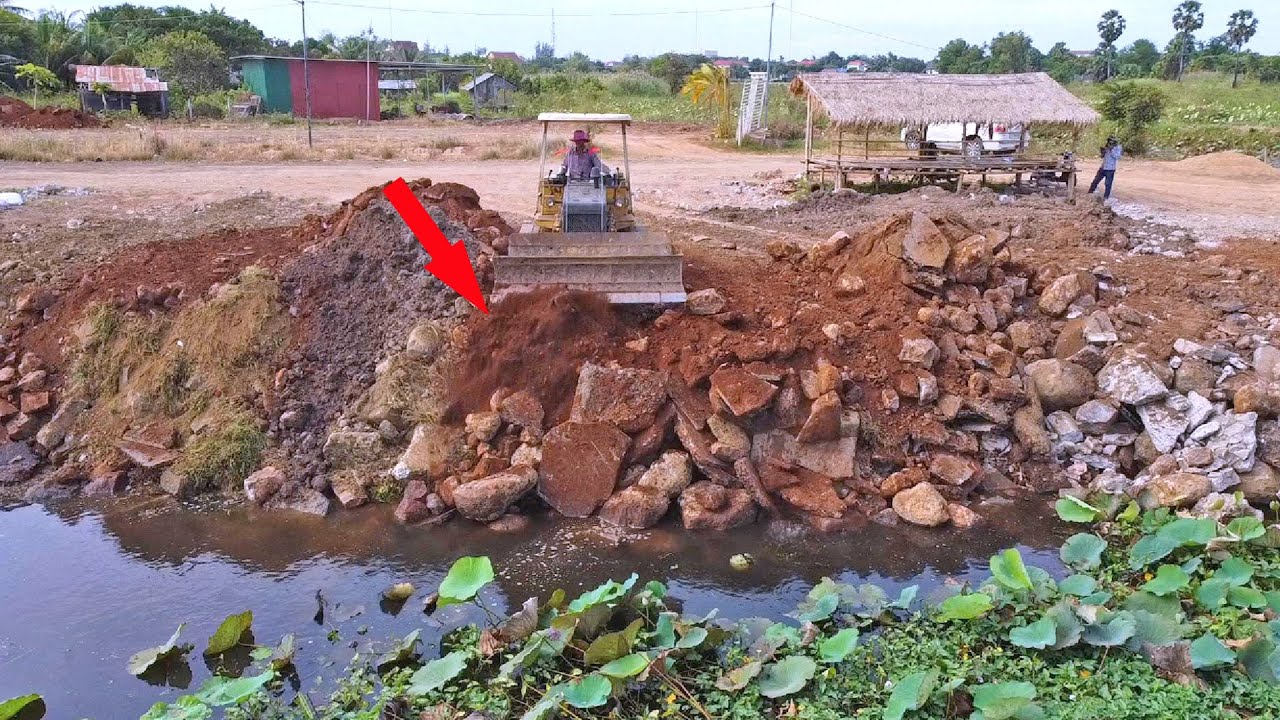 Building a Solid Foundation with Rocks and Soil Strengthening the Riverbank with Precision