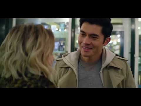 Last Christmas (2019) official trailer frame: Emilia Clarke and Henry Golding under London Christmas lights