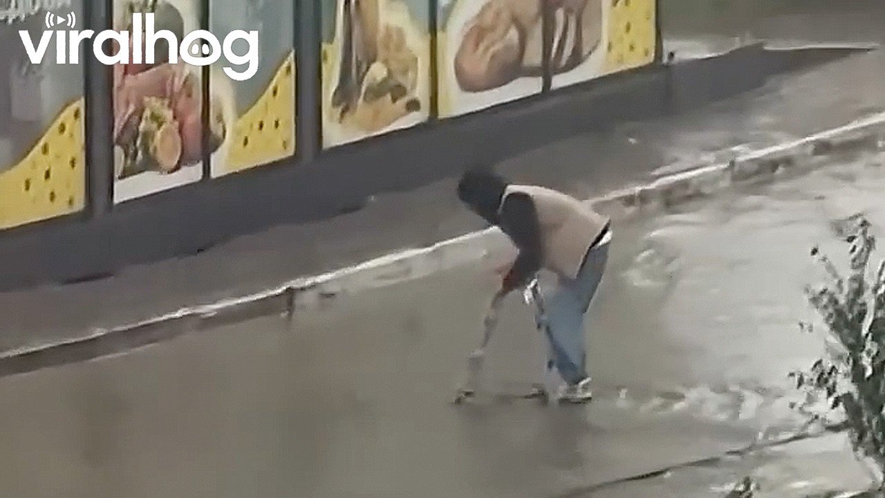 Man Crosses Flooded Street on a Ladder || ViralHog