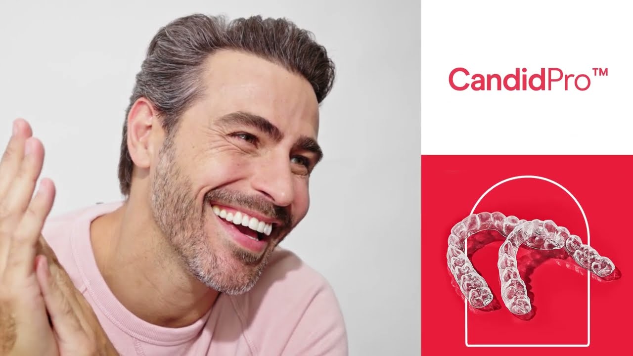 Smiling man with Candid Pro clear aligners