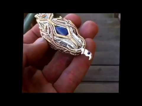 Quad directional, high end, wire wrap pendant.  Lost wax casted sections with flush settings.