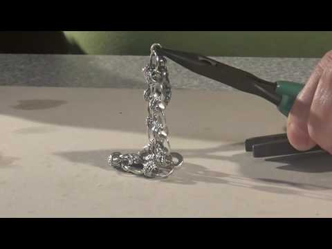 Soldering a charm on a bracelet with a solder gun