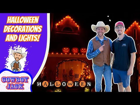 Thumbnail with two men in cowboy outfits beside a pumpkin-lit house at night; left purple panel reads 'HALLOWEEN DECORATIONS AND LIGHTS!' with a Cowboy Jack logo.