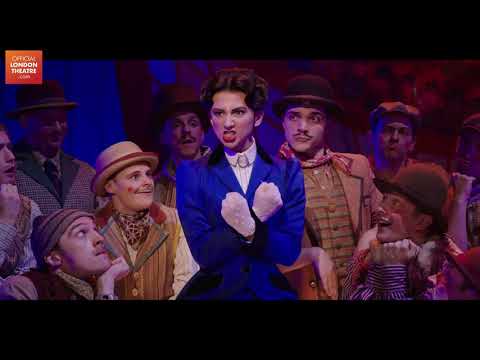 Mary Poppins musical trailer shot of Mary flying above the audience with umbrella during finale