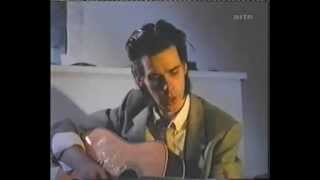 Nick Cave plays guitar