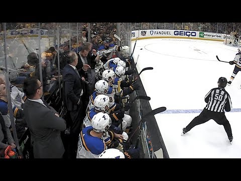Jake Allen gloves puck on bench, gifts souvenir to young fan