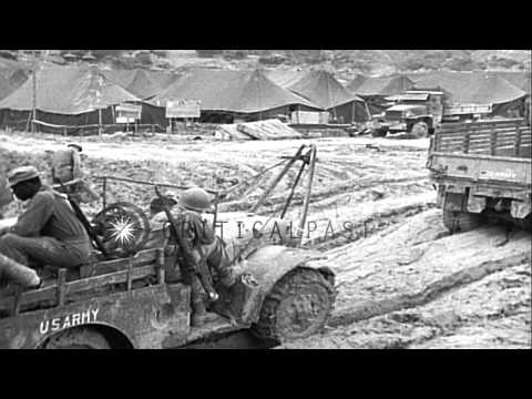 Command vehicles and 3/4 ton Dodge weapons carriers move through mud in Ryukyu Is...HD Stock Footage