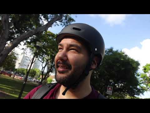 Thumbnail image for my youtube video "Dusting off the skateboard". It is me wearing my helmet while in park that is very green with trees in the background