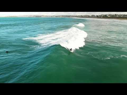 Aerial footage of Bullies surfing on fun day