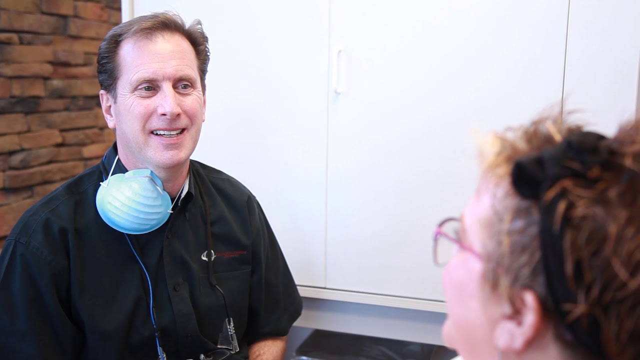 Covington dentist talking to a patient in the dental chair