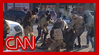 Videos appear to show agent taking gun before Minneapolis shooting