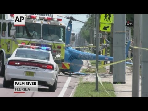 Authorities say a passenger in a truck was killed when a helicopter crashed on a busy Florida street. (April 4)
