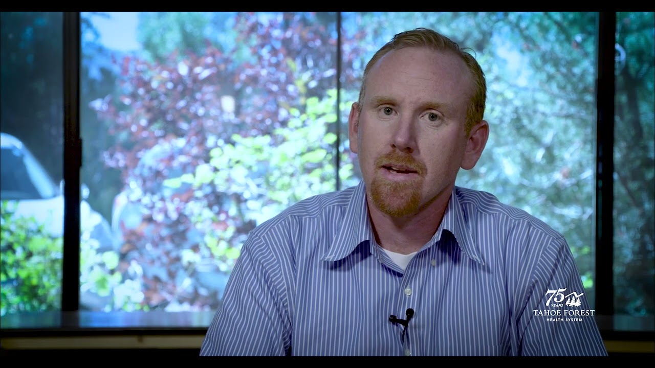 Louis Ward, Chief Operating Officer, sitting in front of a window