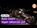 Auto crasht tegen betonnen put, bestuurder zwaargewond