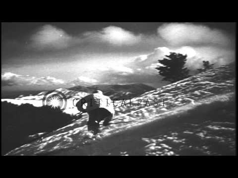 Men sliding downhill and demonstrating the Christianna stem turn technique in the...HD Stock Footage