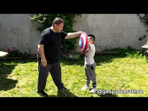 The boy quickly learned from his teacher the technique of defending himself with a shield.