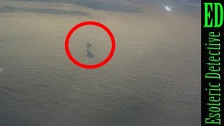 ENORMOUS SHADOWY FIGURE walking on clouds CAUGHT ON CAMERA by Plane passenger at 30,000ft