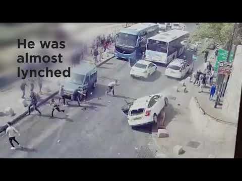 An Israeli driver escapes a violent lynch
