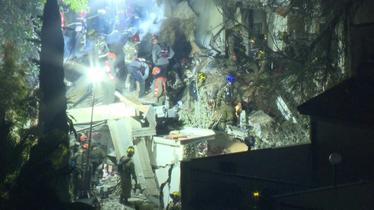 Video | Israeli rescuers search for missing people after building hit by Iran missile | AFP