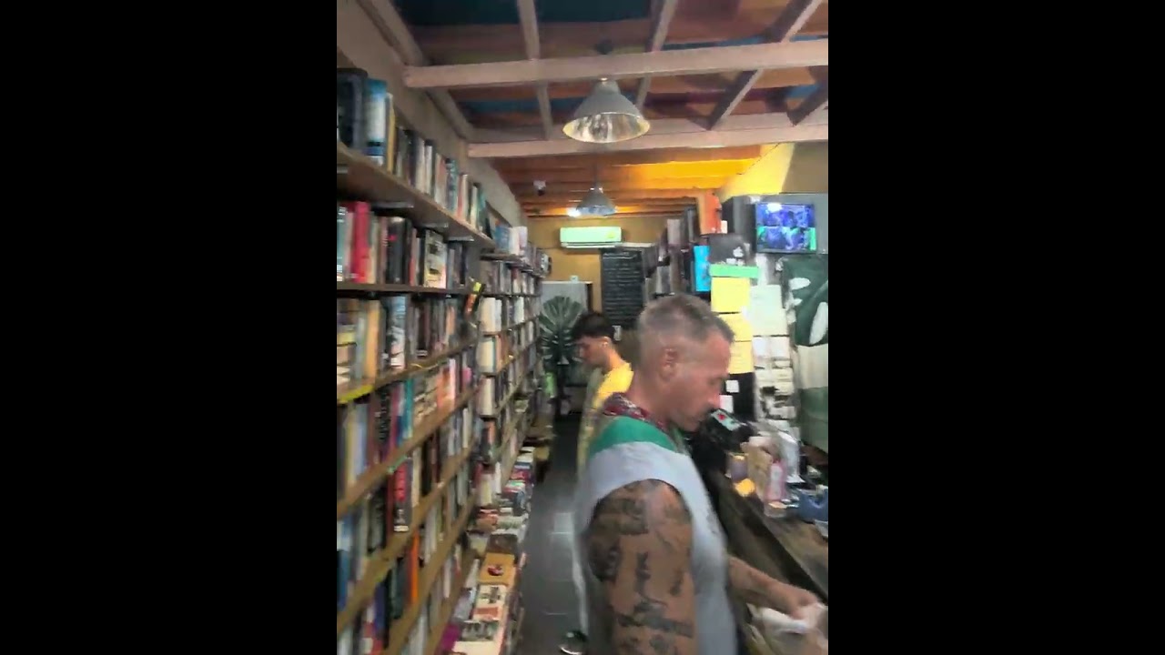 Tattooed Customer Buying Books Today