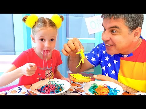 Nastya und Papa bereiten bunte Nudeln zu