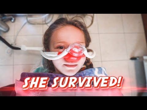 Young girl in a hospital bed wearing an oxygen/nasal mask, with a bold 'SHE SURVIVED!' caption across the image.