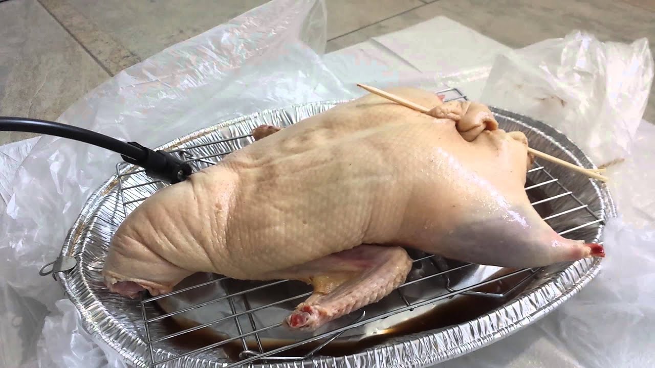 Pumping air to prep a Peking Duck using a bike pump