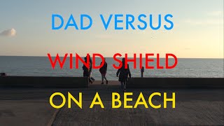 Dad Versus Wind Shield On a Beach
