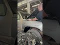 Adjusting an aftermarket fender to get the hood gap right.