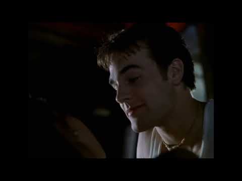 Varsity Blues 1999 trailer frame: Mox steps onto a Texas field under Friday-night lights