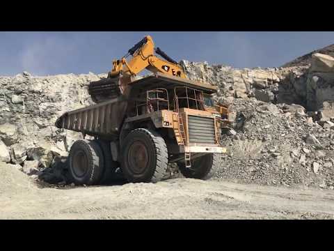 Cat 390D loading cat 777d dump truck