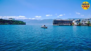 With Walk China . . . Introduction ShuangLang ancient town is a charming and picturesque village located on the eastern shore of ErHai Lake, DaLi, Yunnan province. Known for its tranquil lakeside scenery, traditional Bai architecture, and vibrant arts scene, Shuanglang is an ideal destination for those looking to experience the natural beauty and cultural richness of the region. Getting There By Air: The nearest airport is Dali Airport (DLU). From the airport, you can take a bus or hire a taxi to Shuanglang, which is about 50 km away. By Train: The nearest major train station is in Dali. From Dali, you can take a bus or taxi to Shuanglang, which takes about an hour. By Bus: Direct buses run from Dali Ancient Town to Shuanglang, providing a convenient and scenic route along Erhai Lake. Best Time to Visit The best time to visit Shuanglang is during the spring (March to May) and autumn (September to November) when the weather is mild and pleasant. Summers can be hot and rainy, while winters are cooler but still enjoyable for sightseeing. Main Attractions Erhai Lake: Shuanglang is situated on the shores of Erhai Lake, offering stunning views and opportunities for boating, cycling, and lakeside walks. Moon Palace: A popular landmark in Shuanglang, the Moon Palace is known for its beautiful architecture and panoramic views of Erhai Lake. Yuji Island: Accessible by boat, this small island is home to a variety of art galleries, cafes, and boutique shops, making it a great spot for a day trip. Jinsuo Island: Another nearby island worth visiting, known for its traditional Bai village and tranquil atmosphere. Benzhu Temple: A historic temple dedicated to local deities, providing insight into the spiritual and cultural heritage of the Bai people. Cultural Highlights Bai Ethnic Culture: Shuanglang is predominantly inhabited by the Bai ethnic group. Explore their unique customs, traditional Bai houses, and vibrant festivals. Art and Craft: Shuanglang is known for its thriving arts scene. Visit local art galleries, workshops, and boutiques to see the work of local artists and artisans. Local Festivals: Experience traditional Bai festivals such as the Third Month Fair and the Torch Festival, which feature music, dance, and local cuisine. Accommodation Shuanglang offers a range of accommodation options, from luxury boutique hotels to budget-friendly guesthouses. Some recommended places to stay include: Sky Valley Heritage Boutique Hotel: A luxury hotel offering stunning views of Erhai Lake and elegant, traditionally designed rooms. Sea & Moon Inn: A mid-range hotel with comfortable rooms and a beautiful lakeside location. Shuanglang Daxie Homestay: A budget-friendly guesthouse providing a cozy and authentic experience of local hospitality. Dining Local Cuisine: Shuanglang is known for its fresh lake fish, traditional Bai dishes, and local specialties. Don`t miss trying Erhai Lake fish hotpot, Bai-style grilled fish, and various wild mushroom dishes. Restaurants: Recommended eateries include Spring of Small Town, Qingyu Restaurant, and Yixiangxuan Restaurant. Conclusion Shuanglang Ancient Town offers a serene and culturally enriching travel experience. Whether you`re exploring the scenic shores of Erhai Lake, delving into the rich Bai culture, or simply relaxing in a lakeside café, Shuanglang promises a memorable and peaceful retreat. The beautiful ShuangLang ancient town, ErHai Lake, DaLi, YunNan province