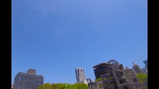 原爆ドーム上空にニコちゃんマークが描かれる「Fly for ALL #大空を見上げよう」